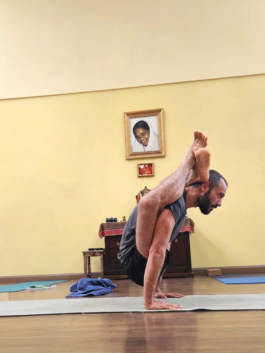 Jose practicing an advanced arm balance